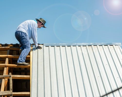 carpenter-repairs-the-roof-of-a-house-in-hot-weather.jpg